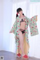 A woman in a kimono is posing for a picture.