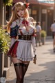 A woman dressed in a maid outfit is walking down the street.