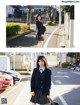 A woman in a school uniform is walking down the street.