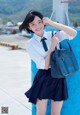 A young woman in a school uniform posing for a picture.